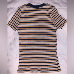 girls striped top, with blue yellow and white strips.